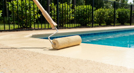 Applying the protective sealer during a Jacksonville pool deck sealing project